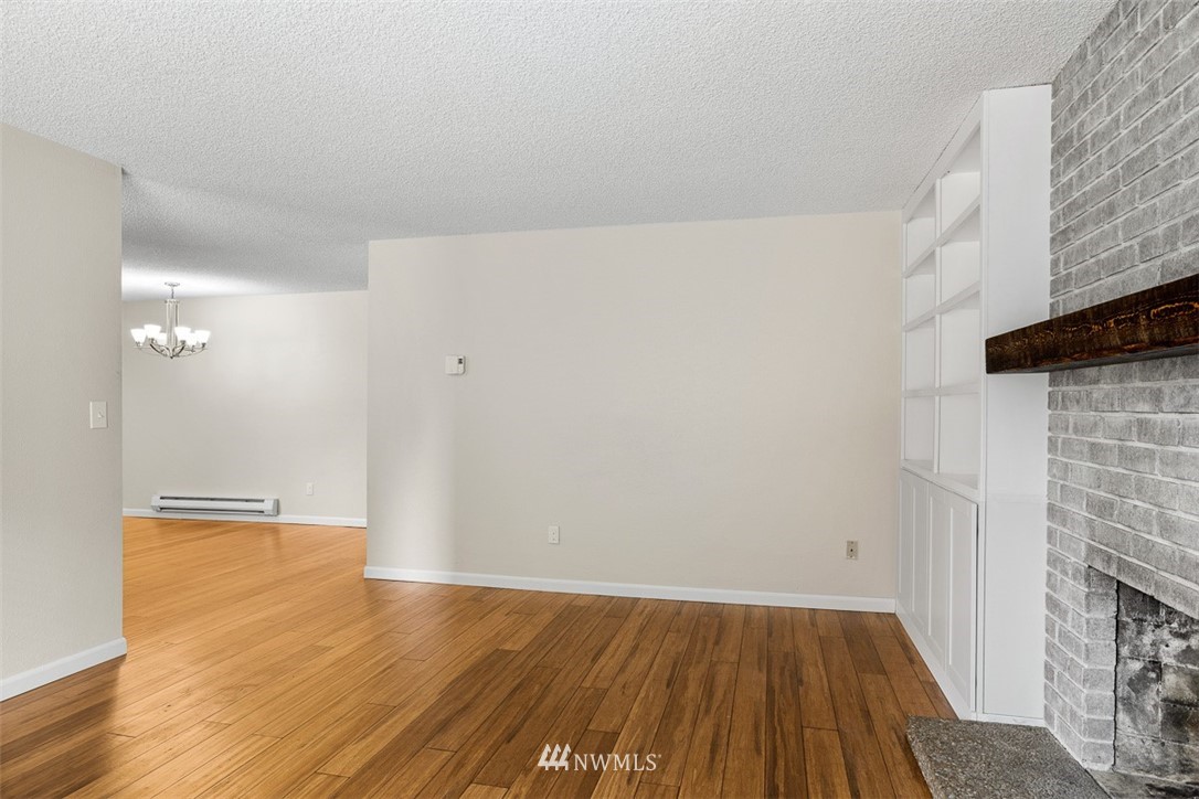 16505 23rd Avenue Southeast Bothell, WA 98012 - Photo 11 of 33 a view of an empty room with wooden floor and a fireplace