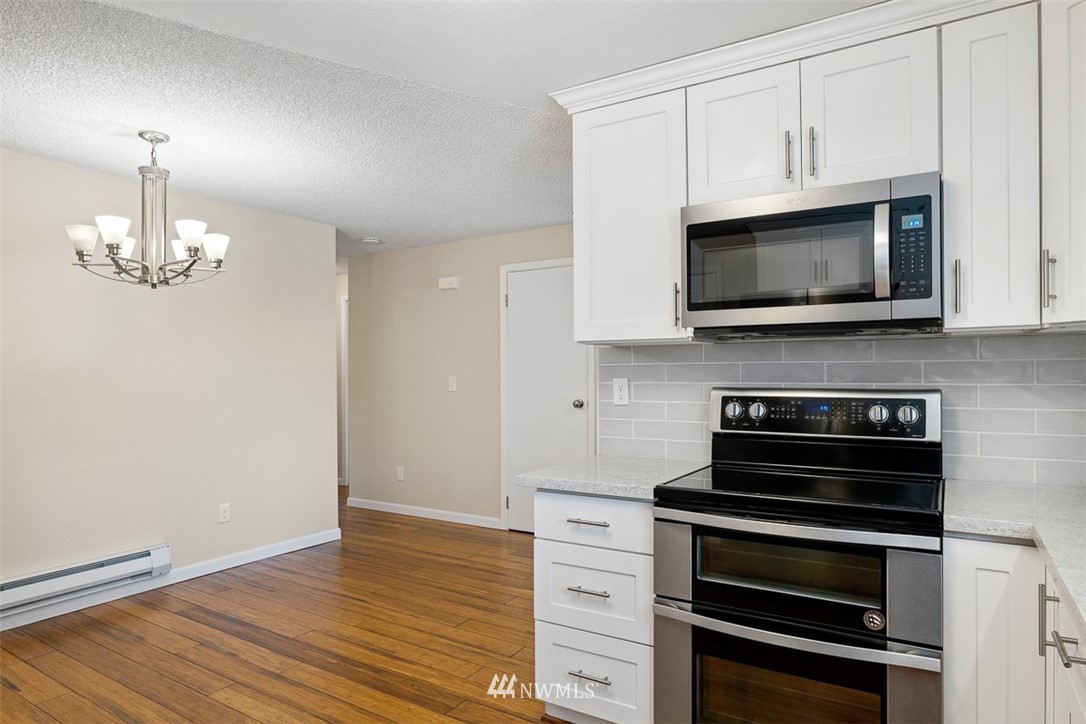 16505 23rd Avenue Southeast Bothell, WA 98012 - Photo 13 of 33 a kitchen with granite countertop a stove and a microwave