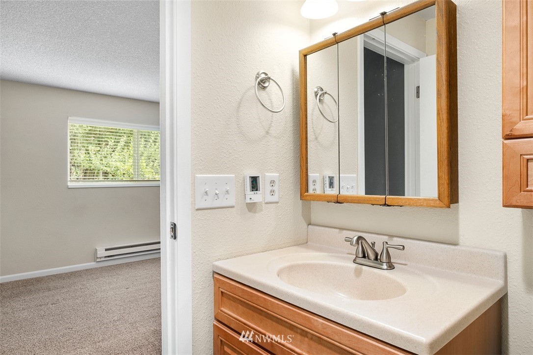 16505 23rd Avenue Southeast Bothell, WA 98012 - Photo 18 of 33 a bathroom with a sink vanity and a mirror