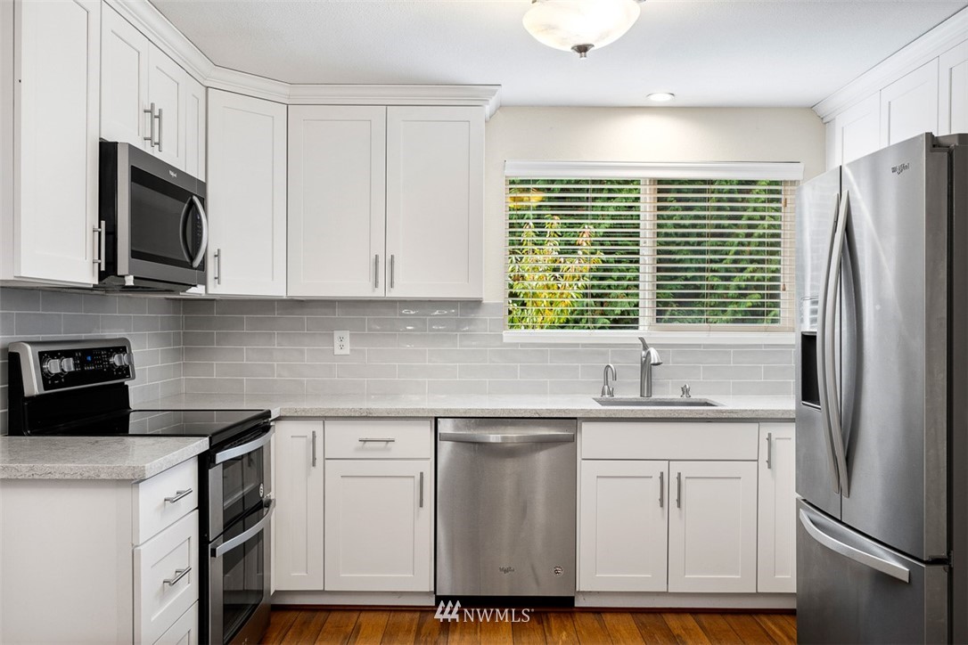 16505 23rd Avenue Southeast Bothell, WA 98012 - Photo 3 of 33 a kitchen with white cabinets stainless steel appliances and a window