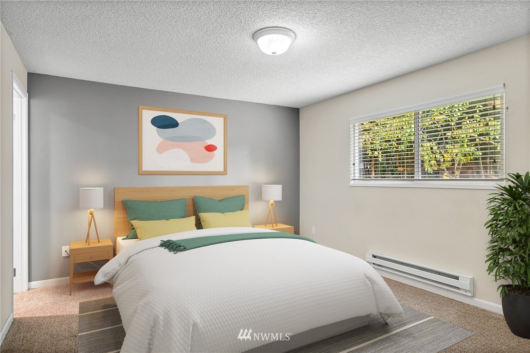 16505 23rd Avenue Southeast Bothell, WA 98012 - Photo 5 of 33 a bedroom with a large bed and a potted plant