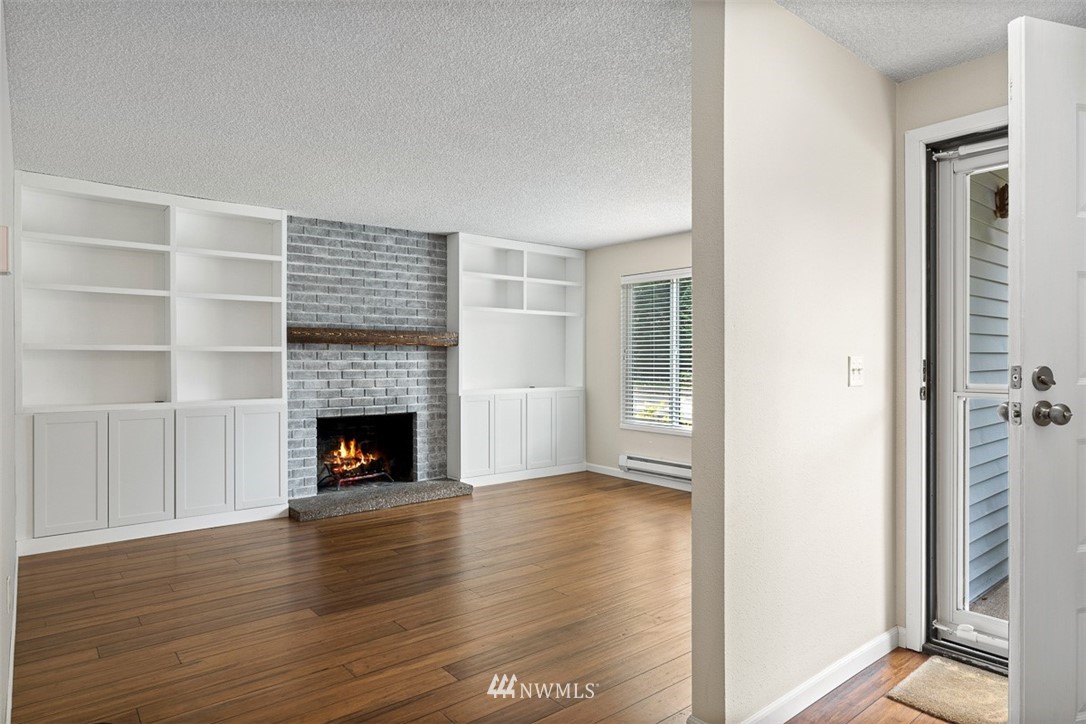 16505 23rd Avenue Southeast Bothell, WA 98012 - Photo 9 of 33 a view of a livingroom with wooden floor and a fireplace