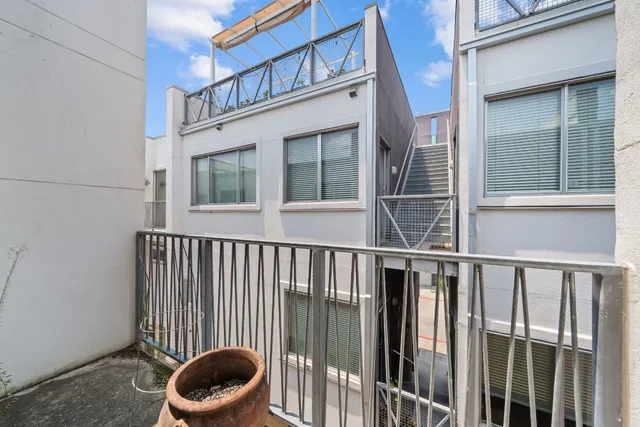 a view of balcony with wooden floor and fence