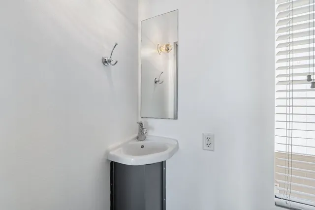 a bathroom with a sink a mirror and shower