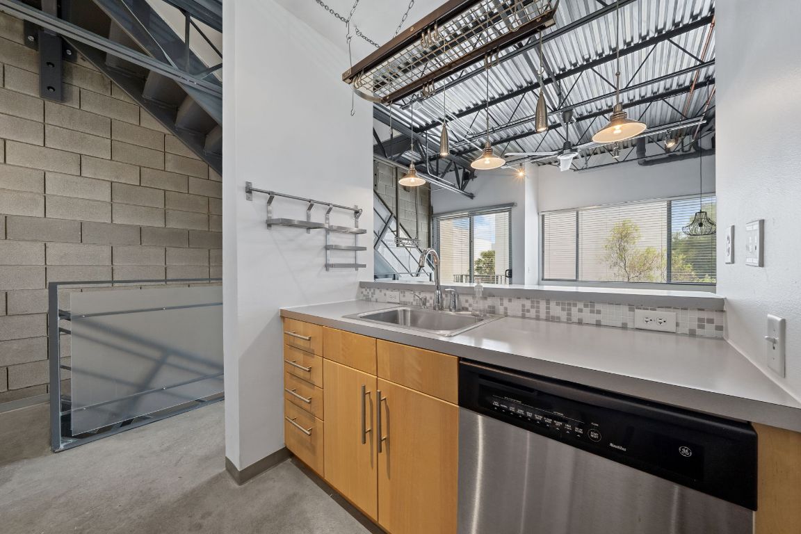 4801 South Congress Avenue, Unit D4 Austin, TX 78745 - Photo 9 of 27 a kitchen with stainless steel appliances a sink and cabinets