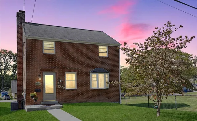 a front view of a house with a yard