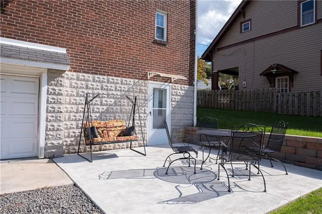 a building outdoor space with patio furniture and potted plants