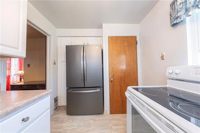 a kitchen with a refrigerator and a sink