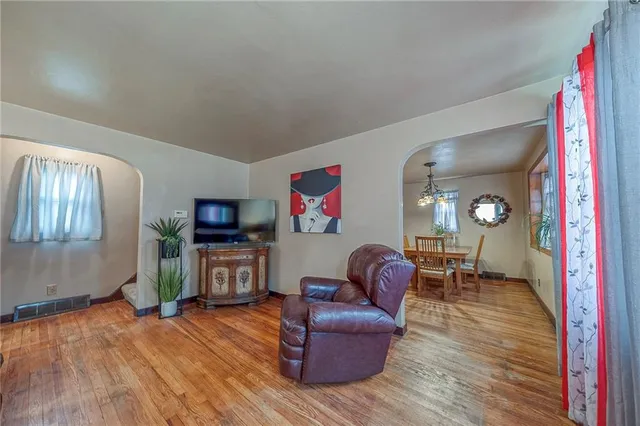 a view of a dining room with furniture a livingroom and chandelier