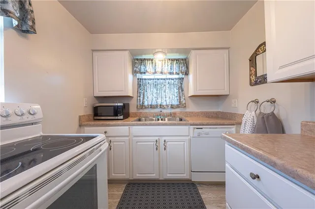 a kitchen with a sink stove and cabinets