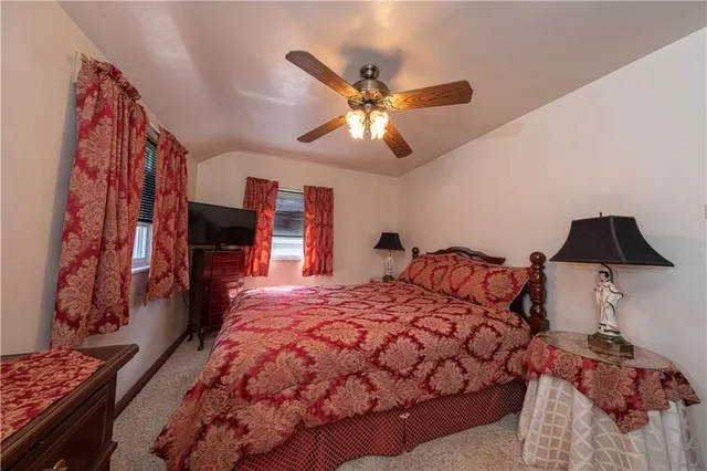 a bedroom with a bed and a television