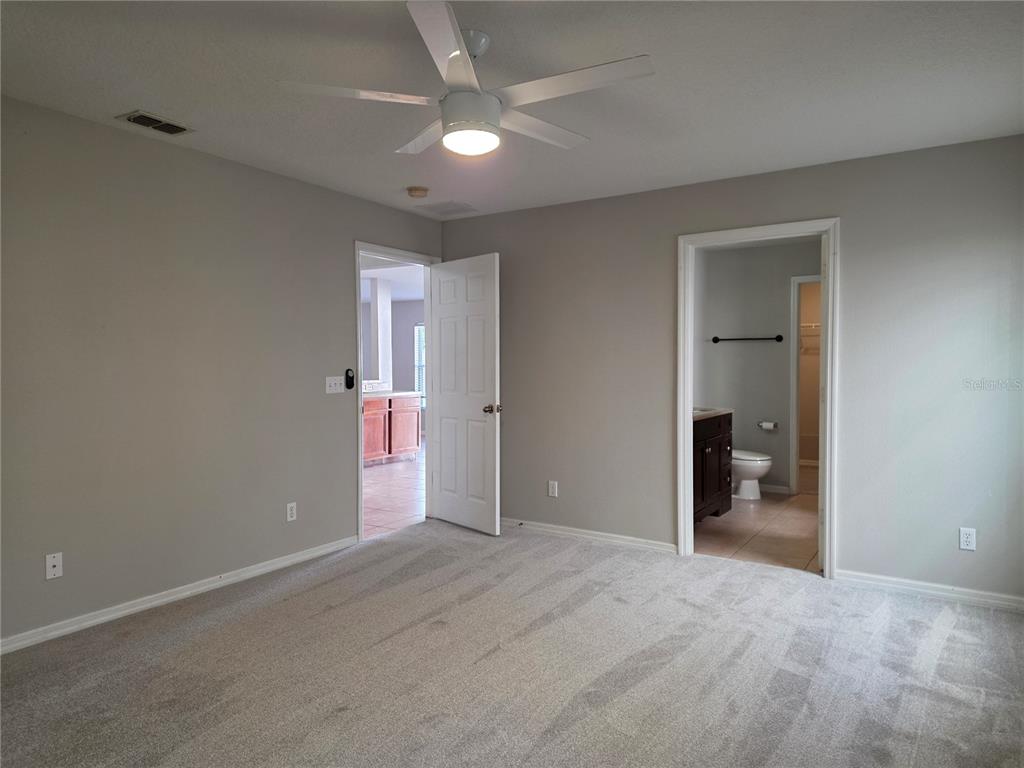 1645 Algonkin Loop Orlando, FL 32828 - Photo 16 of 37 an empty room with fan and entrance