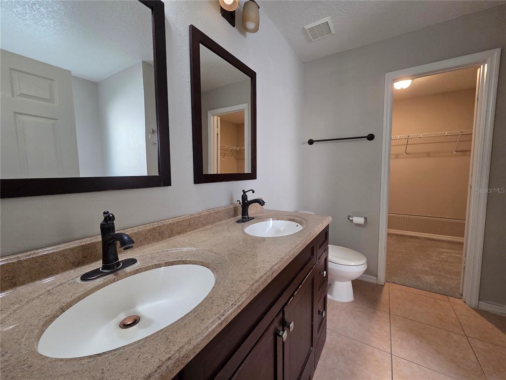 1645 Algonkin Loop Orlando, FL 32828 - Photo 17 of 37 a bathroom with a sink and a mirror