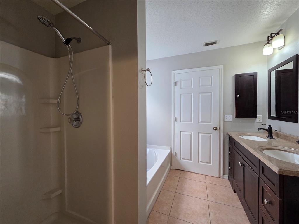 1645 Algonkin Loop Orlando, FL 32828 - Photo 18 of 37 a bathroom with a double vanity sink and mirror