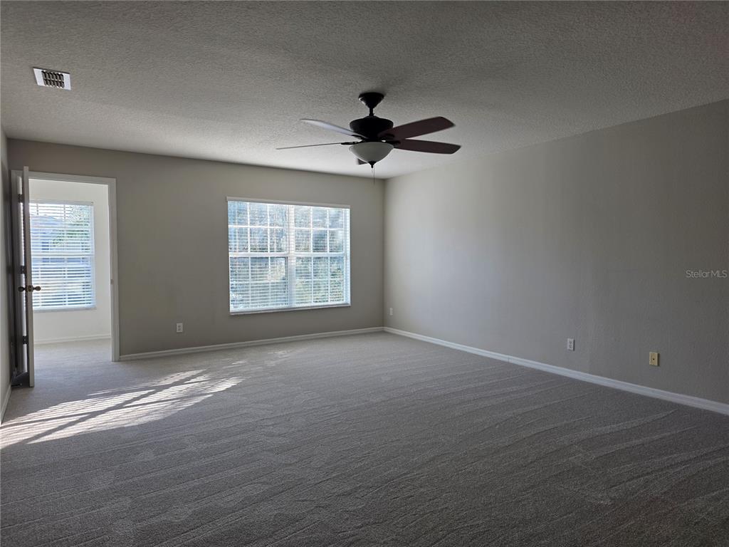 1645 Algonkin Loop Orlando, FL 32828 - Photo 26 of 37 an empty room with windows and fan