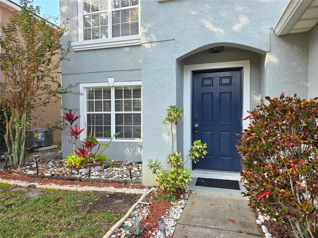 1645 Algonkin Loop Orlando, FL 32828 - Photo 3 of 37 a front view of a house with a yard