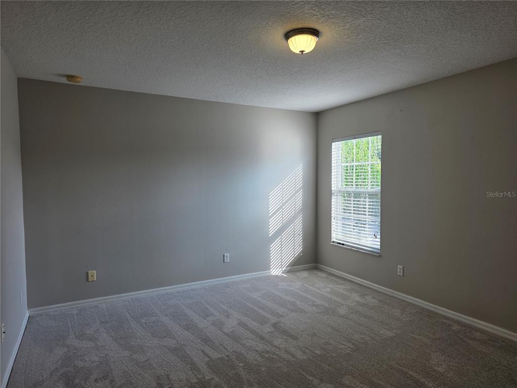 1645 Algonkin Loop Orlando, FL 32828 - Photo 35 of 37 an empty room with windows