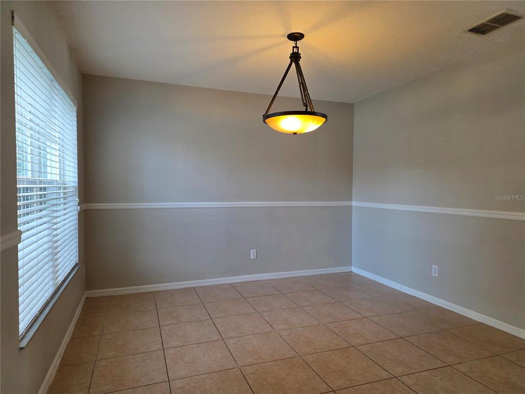 1645 Algonkin Loop Orlando, FL 32828 - Photo 5 of 37 a view of a room with a light fixture and a window