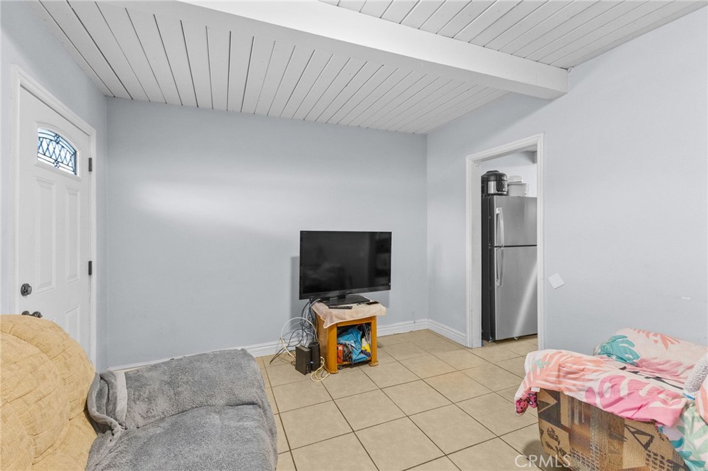 18585 14th Street Bloomington, CA 92316 - Photo 4 of 19 a living room with furniture and a flat screen tv