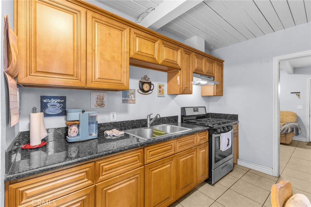 18585 14th Street Bloomington, CA 92316 - Photo 7 of 19 a kitchen with stainless steel appliances granite countertop a sink stove and cabinets