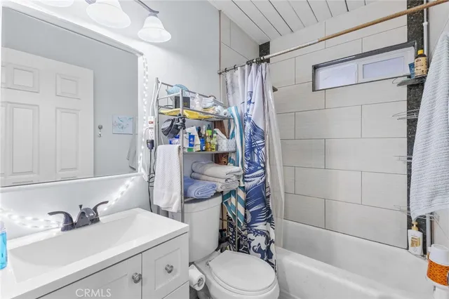 a bathroom with a sink toilet tub and shower