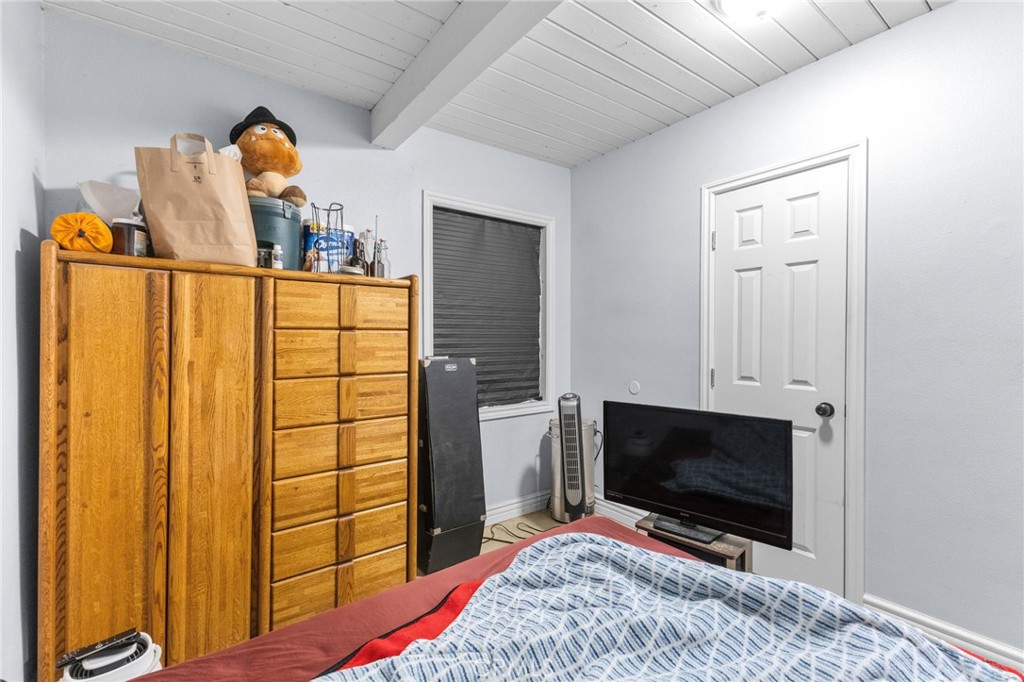 18585 14th Street Bloomington, CA 92316 - Photo 9 of 19 a bedroom with a bed and a flat screen tv