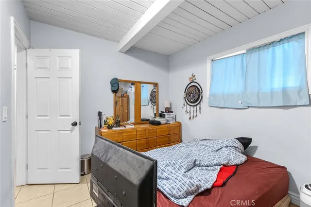 a bedroom with a bed and a table in it