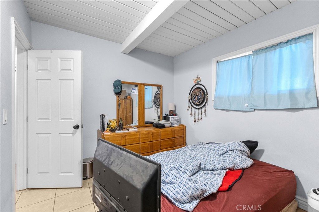 18585 14th Street Bloomington, CA 92316 - Photo 10 of 19 a bedroom with a bed and a table in it