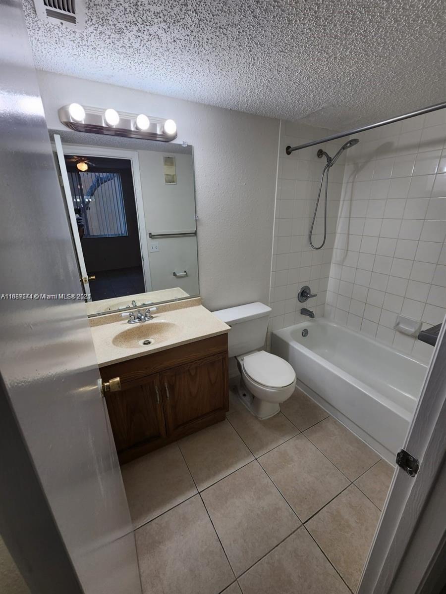 Palm Aire Pompano Beach, FL 33069 - Photo 3 of 8 a bathroom with a granite countertop sink a toilet a mirror and shower