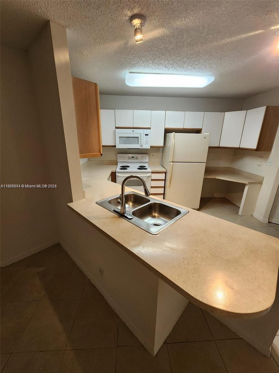 Palm Aire Pompano Beach, FL 33069 - Photo 6 of 8 a view of kitchen and sink