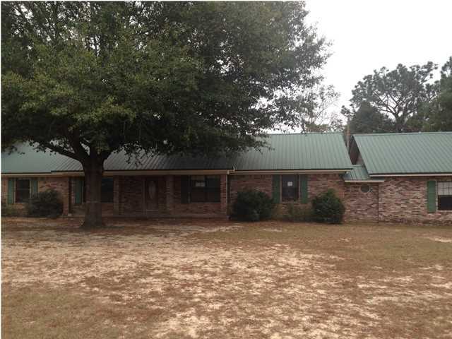 1086 Tallokas Road Crestview, FL 32536 - Photo 1 of 34 a front view of a house with a yard