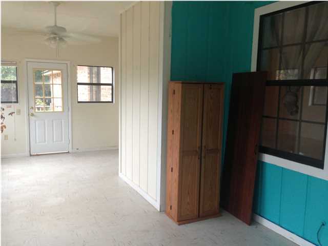 1086 Tallokas Road Crestview, FL 32536 - Photo 18 of 34 an empty room with windows and cabinet