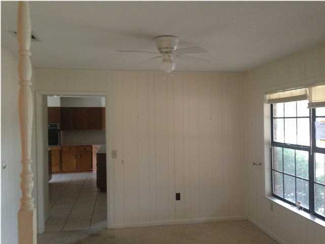 1086 Tallokas Road Crestview, FL 32536 - Photo 22 of 34 an empty room with windows and cabinet