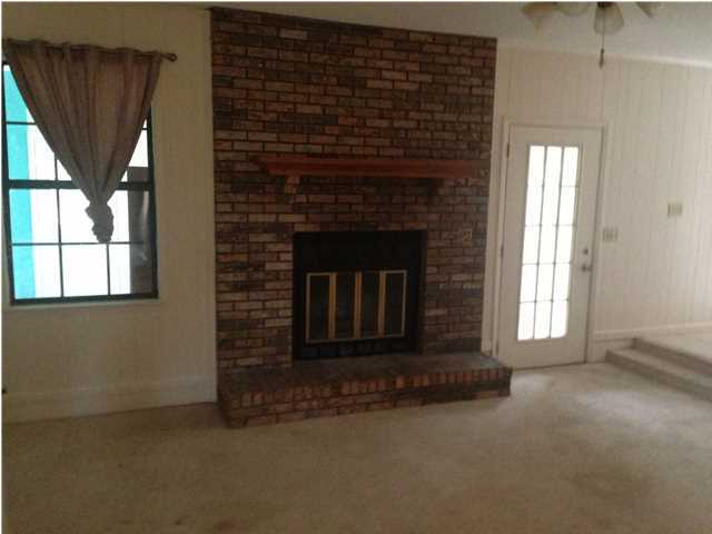 1086 Tallokas Road Crestview, FL 32536 - Photo 23 of 34 a living room with a fireplace in front of a window