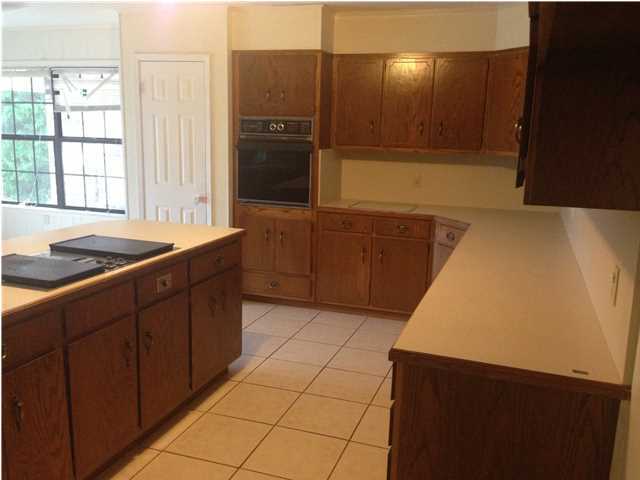 1086 Tallokas Road Crestview, FL 32536 - Photo 7 of 34 a kitchen with a sink and a refrigerator