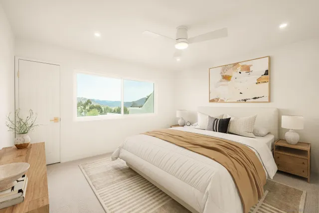 a bedroom with a large bed and a window