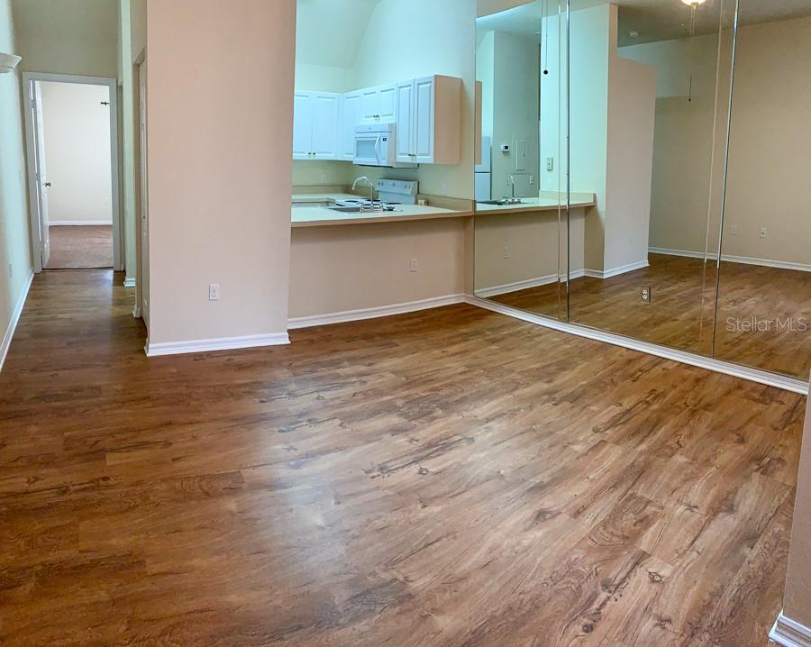 3901 Southwest 27th Street, Unit 5 Gainesville, FL 32608 - Photo 14 of 15 an empty room with wooden floor and bathroom