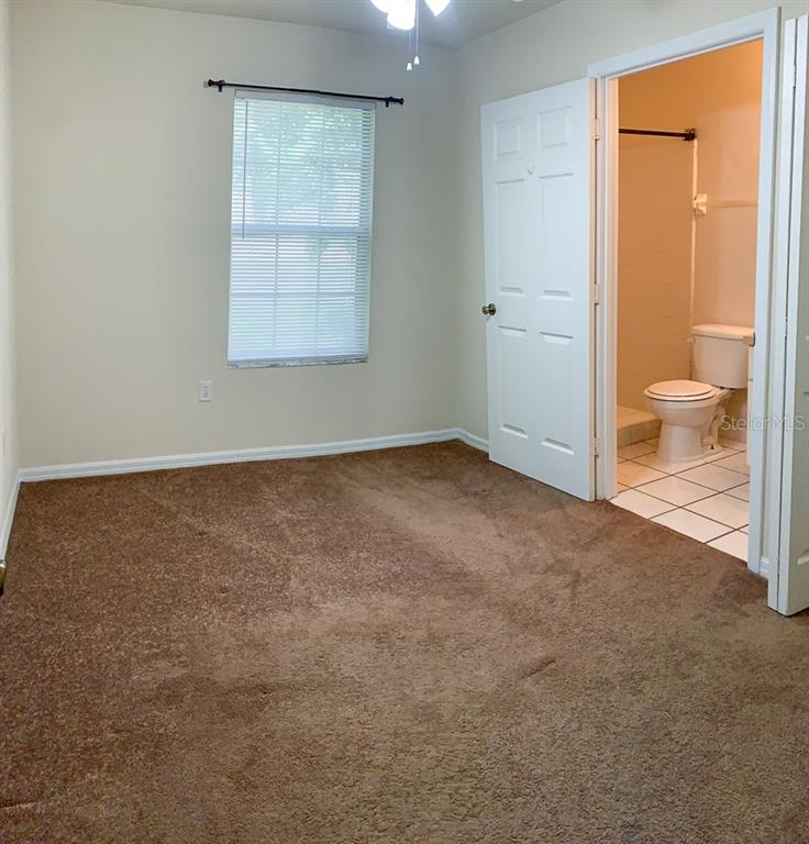 3901 Southwest 27th Street, Unit 5 Gainesville, FL 32608 - Photo 9 of 15 an empty room with a bathroom and a toilet
