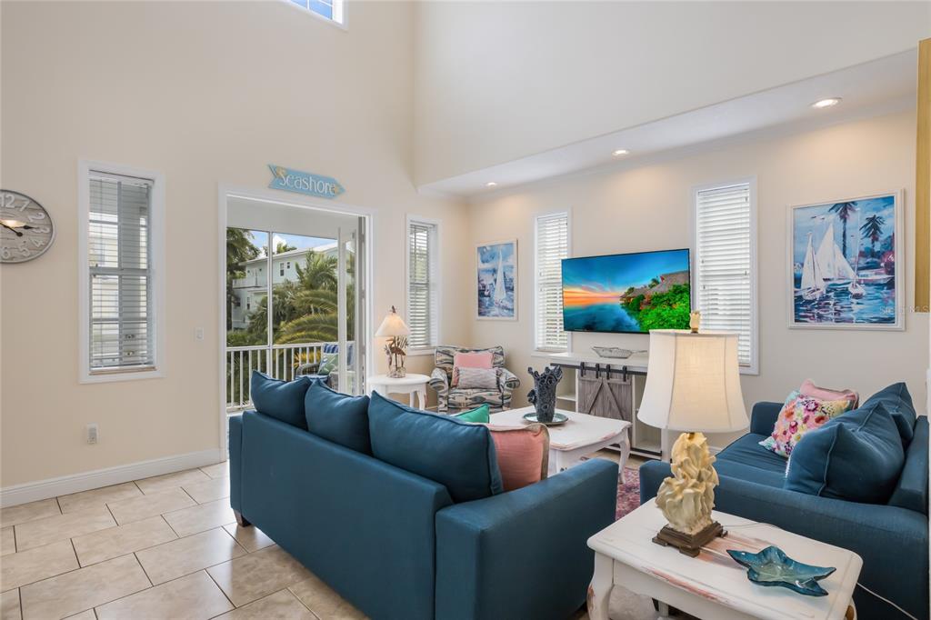 316 64th Street Holmes Beach, FL 34217 - Photo 11 of 43 a living room with furniture and a flat screen tv