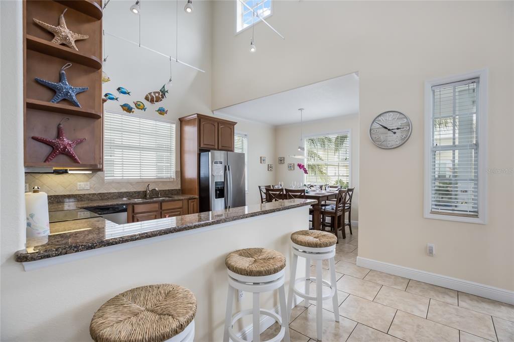 316 64th Street Holmes Beach, FL 34217 - Photo 14 of 43 a kitchen with stainless steel appliances granite countertop a sink a stove and a wooden floors