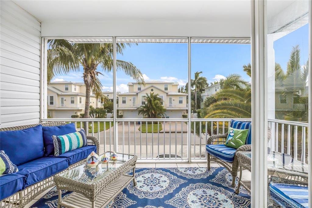 316 64th Street Holmes Beach, FL 34217 - Photo 19 of 43 a living room with furniture and a window