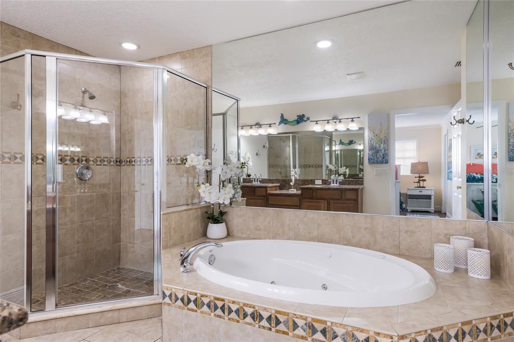 316 64th Street Holmes Beach, FL 34217 - Photo 23 of 43 a bathroom with a bathtub and a shower