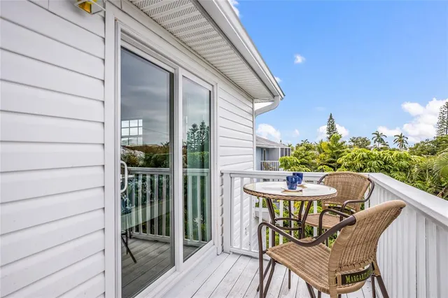 a balcony with table and chairs