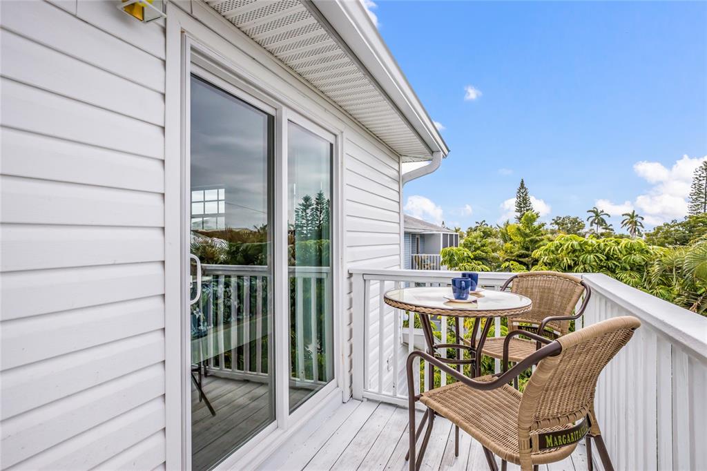 316 64th Street Holmes Beach, FL 34217 - Photo 25 of 43 a balcony with table and chairs