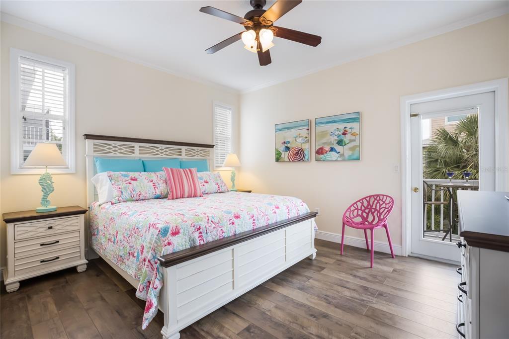 316 64th Street Holmes Beach, FL 34217 - Photo 26 of 43 a bedroom with a bed and a chandelier