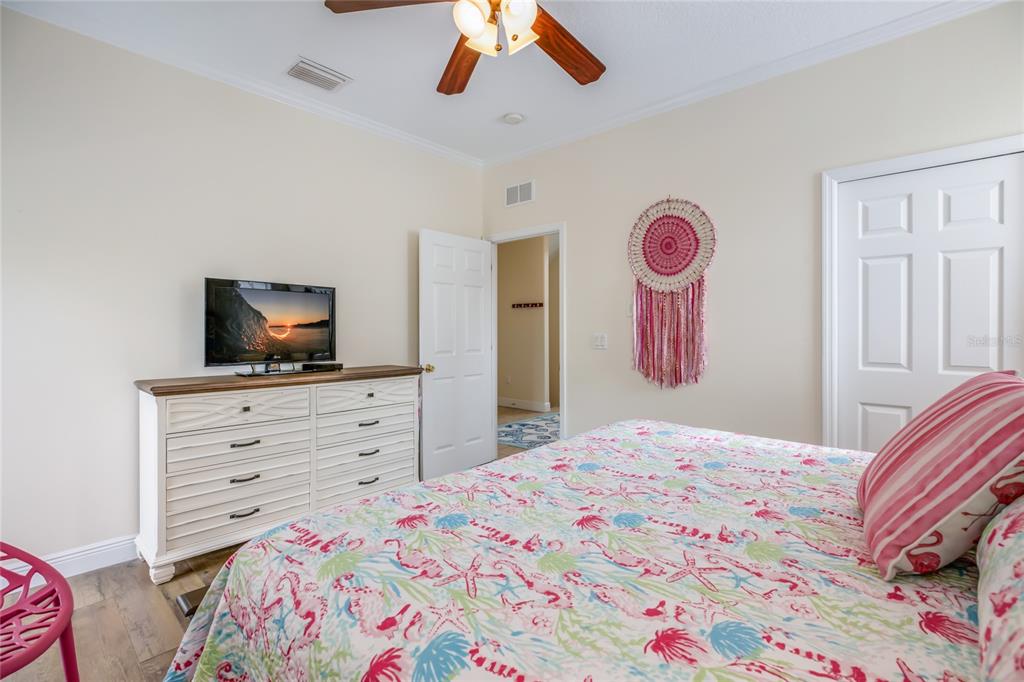 316 64th Street Holmes Beach, FL 34217 - Photo 27 of 43 a bedroom with a bed and a flat screen tv