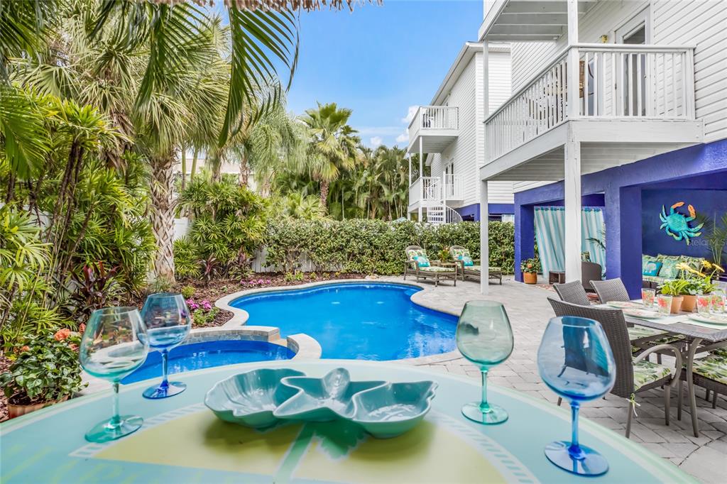 316 64th Street Holmes Beach, FL 34217 - Photo 3 of 43 a view of a swimming pool with outdoor seating