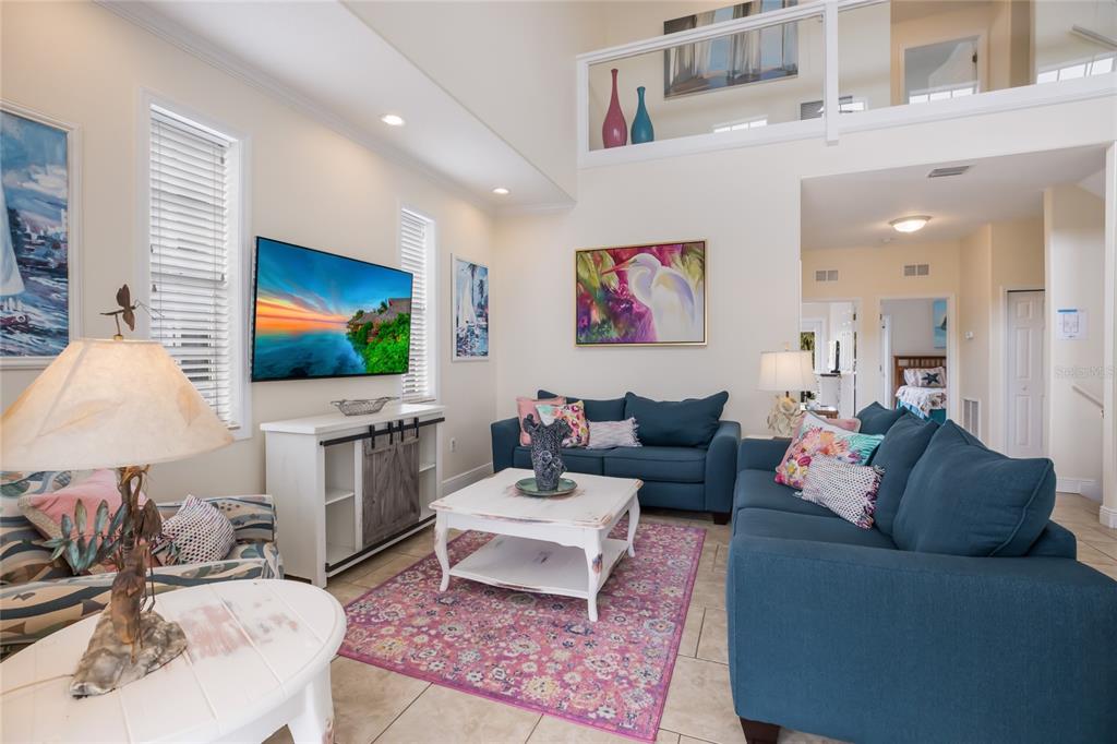 316 64th Street Holmes Beach, FL 34217 - Photo 9 of 43 a living room with furniture and a flat screen tv