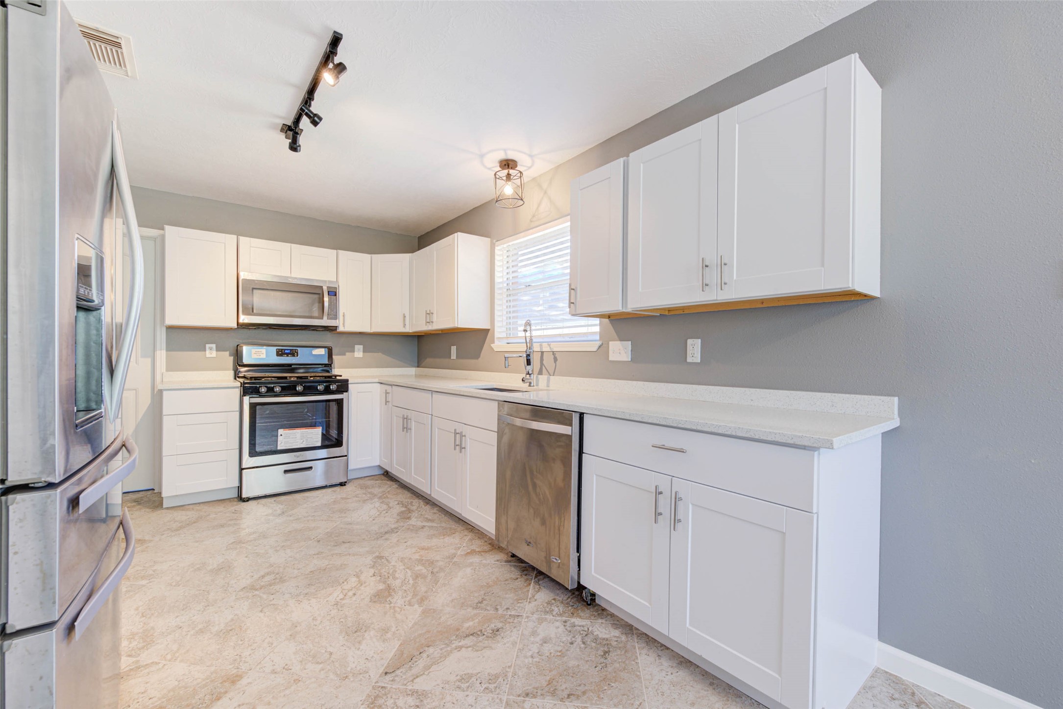 17930 Seven Pines Drive Spring, TX 77379 - Photo 12 of 26 a kitchen with white cabinets and appliances