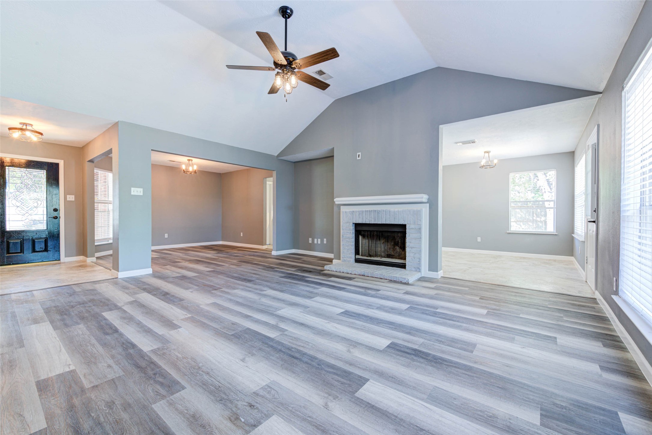 17930 Seven Pines Drive Spring, TX 77379 - Photo 8 of 26 a view of an empty room with wooden floor fireplace and a window